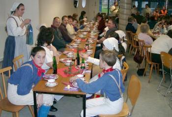 Eltern, Betreuer und die Kindergruppe am Tisch